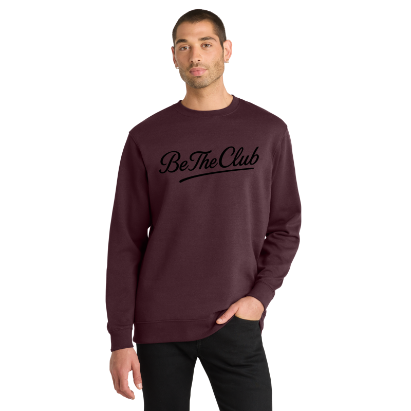 Man wearing a maroon sweatshirt with 'Be The Club' text on a white background