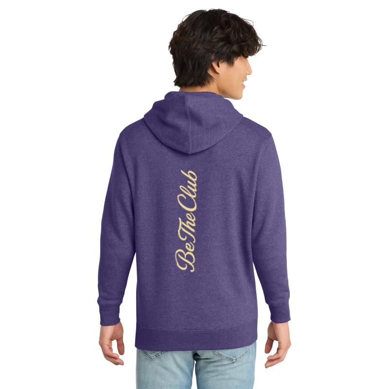 Person wearing a purple hoodie with 'Be The Club' text on the back, standing against a white background