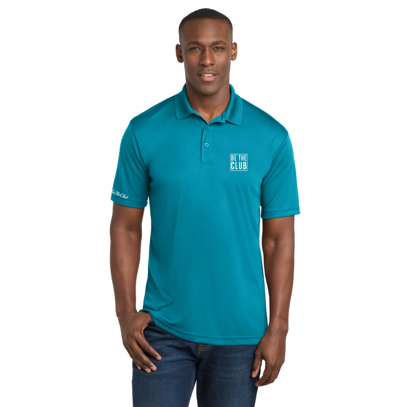 Man wearing a teal polo shirt with a logo on a white background