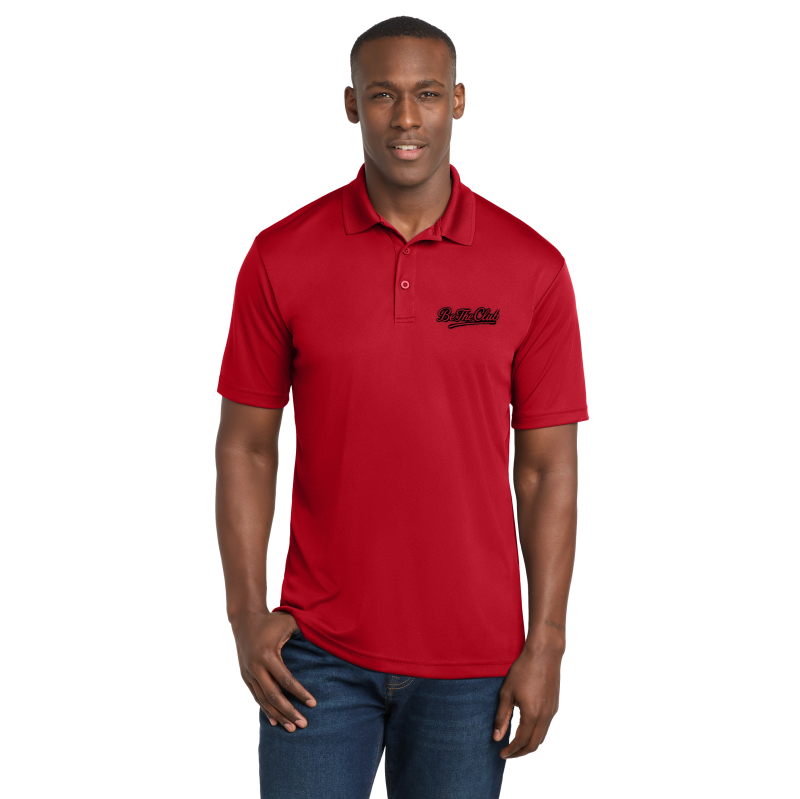 Man wearing a red polo shirt with a logo on a white background