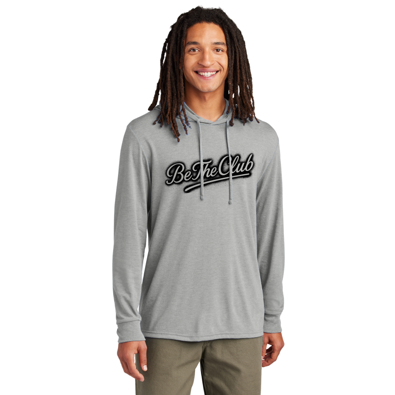 Person wearing a gray hoodie with 'Be The Club' text on a white background