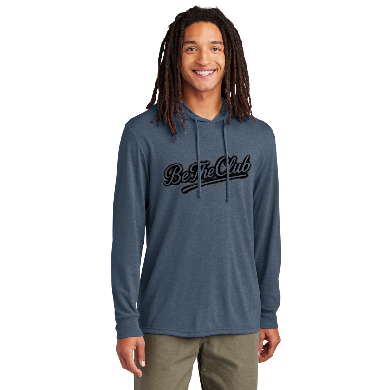 Man wearing a blue hoodie with 'Be The Club' text on a white background
