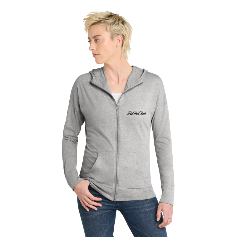 Person wearing a gray hoodie with 'Be The Club' logo on a white background